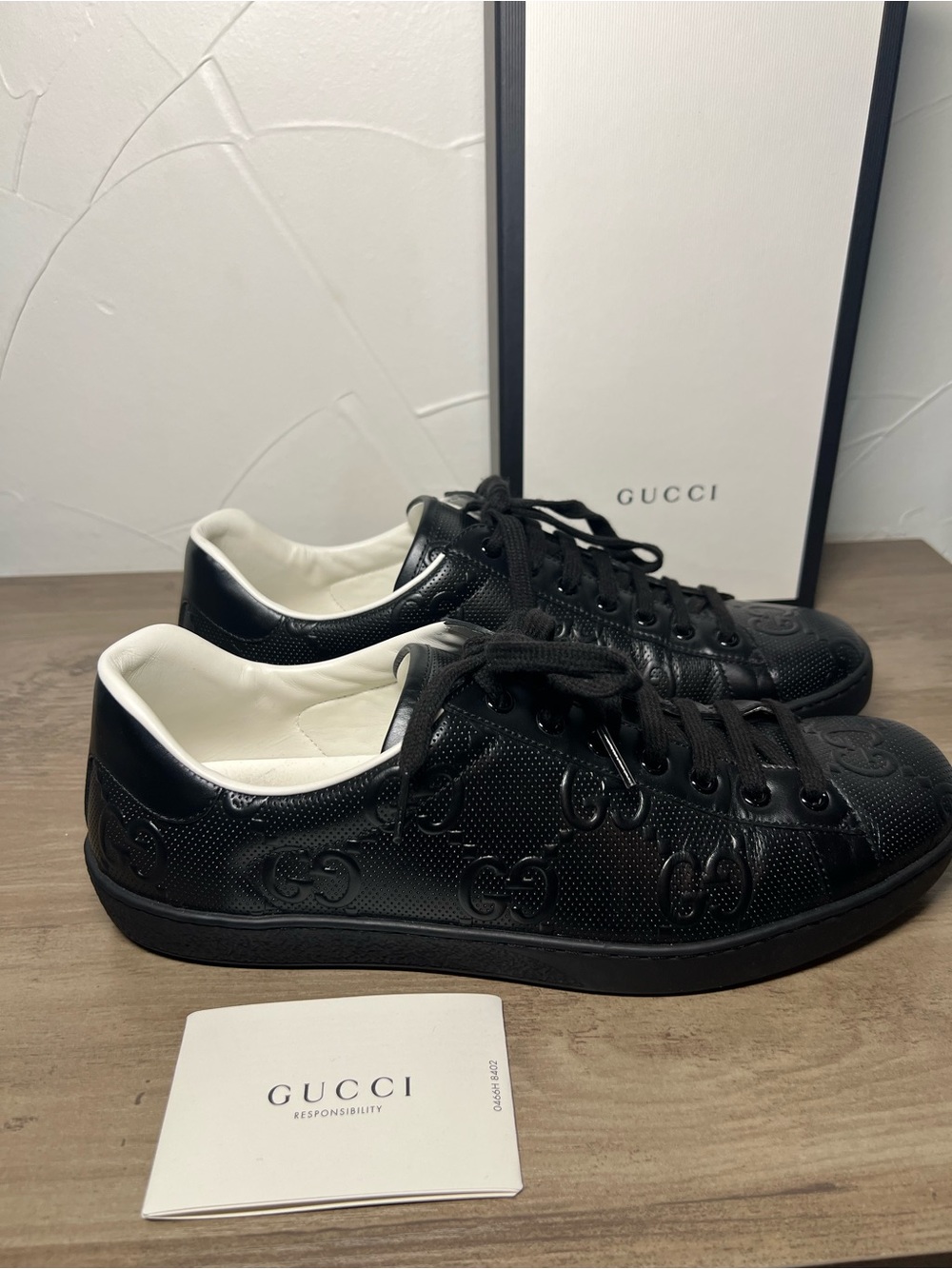 Men’s 10.5 or women’s 12 Gucci Black Embossed GG Leather Sneakers